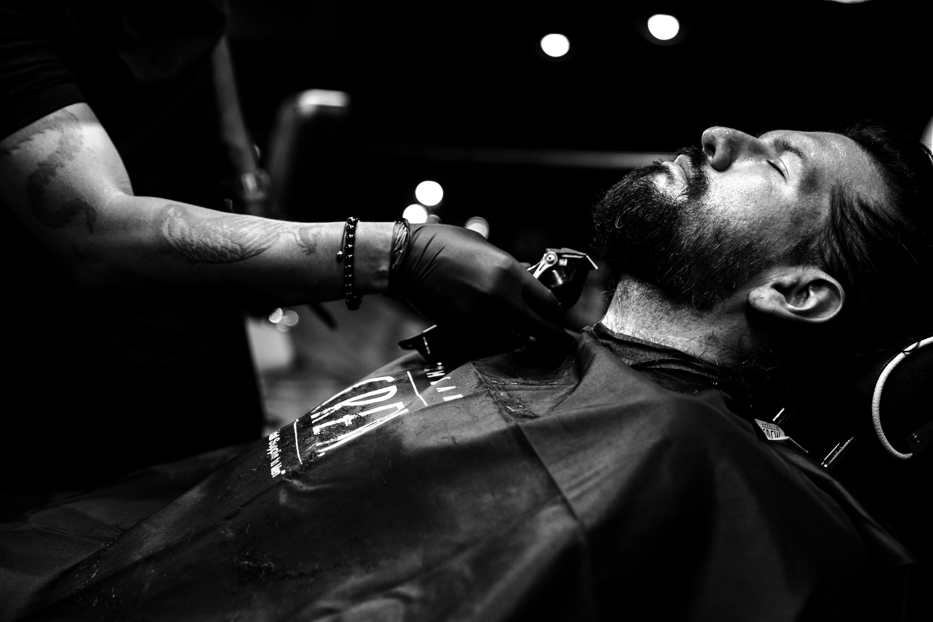 Barber shaping a client's beard